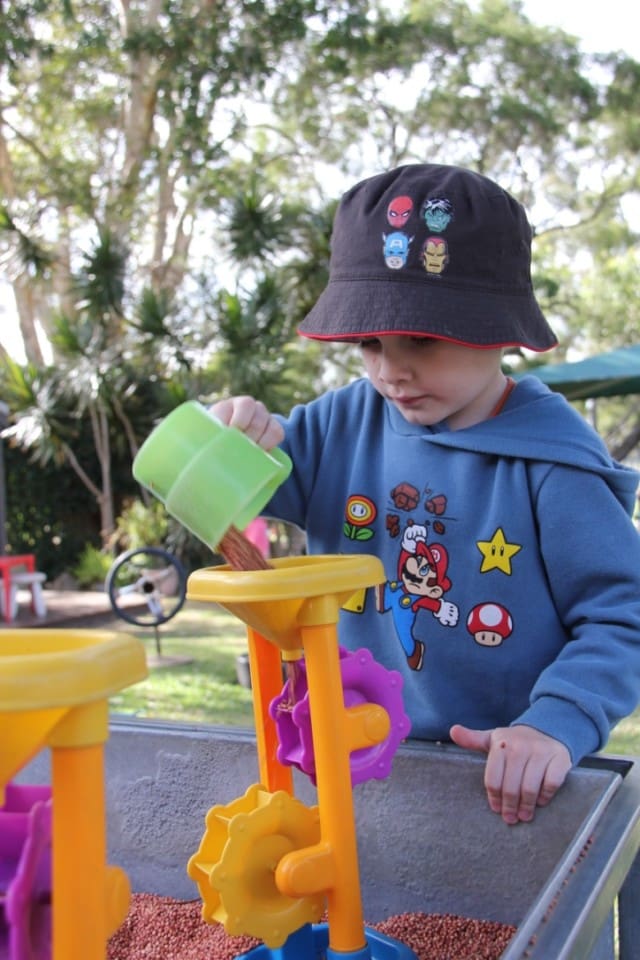 Child playing outside with Kindy equipment