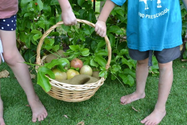 two children holding a basket